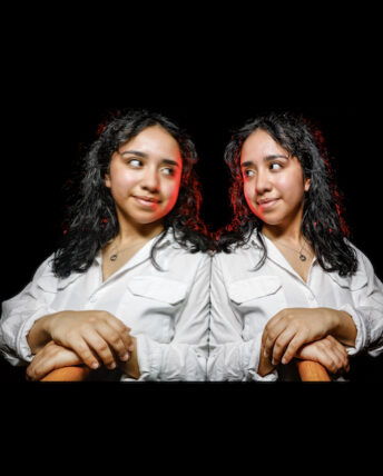 mirror-image style portrait of Monse Castillo against a dark black background